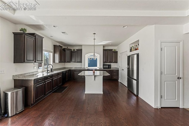 kitchen featuring a kitchen island, dark brown cabinets, a sink, black appliances, and dark wood-style floors