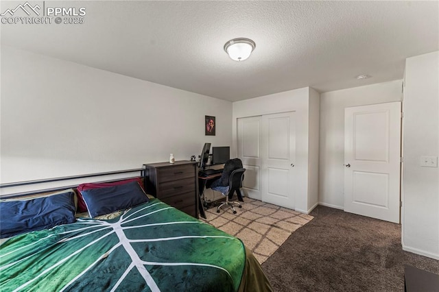 carpeted bedroom with baseboards, a closet, and a textured ceiling