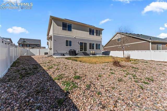 back of house featuring entry steps and a fenced backyard