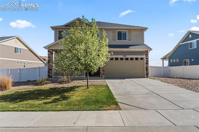 traditional home with a garage, a front lawn, stone siding, and concrete driveway