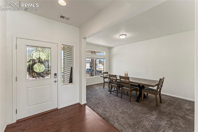 carpeted entrance foyer with baseboards, recessed lighting, wood finished floors, and visible vents