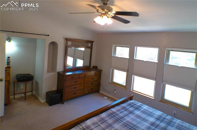 carpeted bedroom featuring visible vents, arched walkways, baseboards, and multiple windows