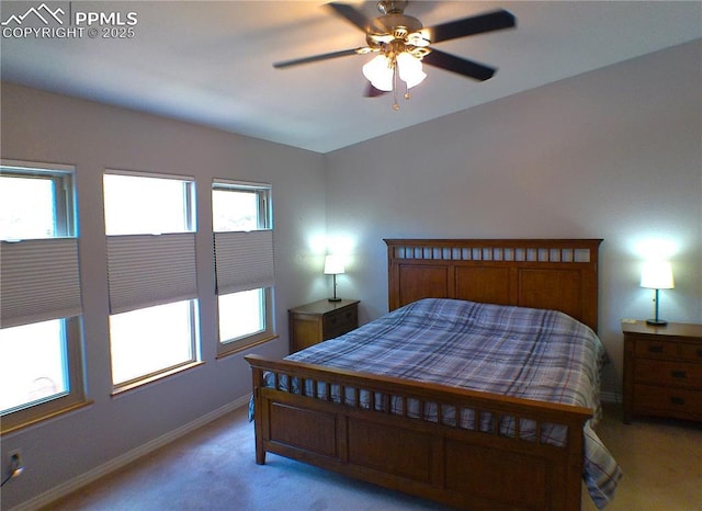 bedroom featuring baseboards, ceiling fan, and light colored carpet