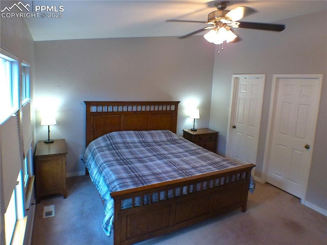 bedroom with baseboards, a ceiling fan, visible vents, and light carpet