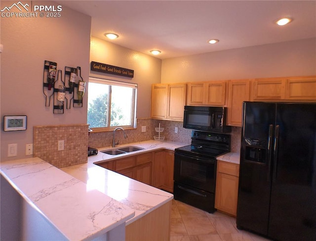 kitchen with tasteful backsplash, a sink, black appliances, a peninsula, and light brown cabinets