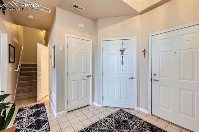 4338 Alder Springs Vw, Colorado Springs, CO 80922 - entrance foyer featuring light tile patterned flooring, baseboards, and stairway