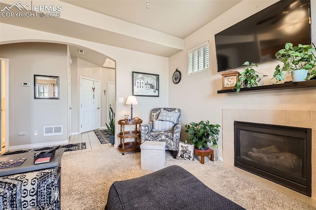 4338 Alder Springs Vw, Colorado Springs, CO 80922 - living room featuring arched walkways, tile patterned flooring, a fireplace, and baseboards