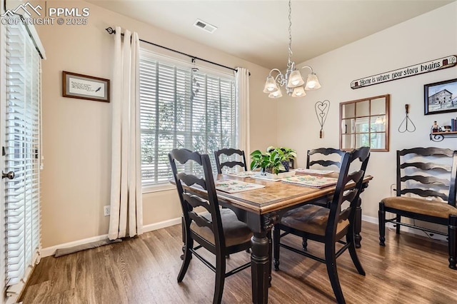 4338 Alder Springs Vw, Colorado Springs, CO 80922 - dining room with wood finished floors, a chandelier, and baseboards