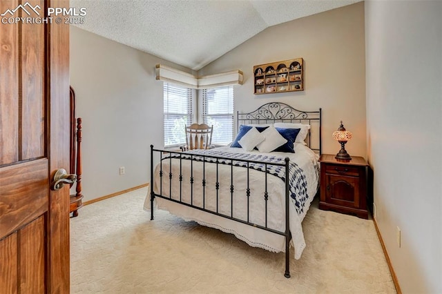 620 Coveglen Ct, Colorado Springs, CO 80906 - bedroom with vaulted ceiling, baseboards, carpet flooring, and a textured ceiling