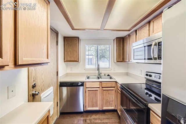1351 Cathay Ct Unit 102, Arapahoe, CO 80017 - kitchen featuring a sink, appliances with stainless steel finishes, dark wood finished floors, and light countertops