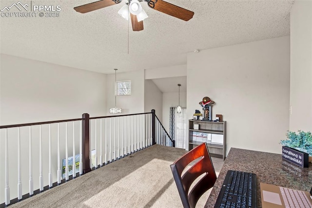 carpeted home office featuring a ceiling fan and a textured ceiling