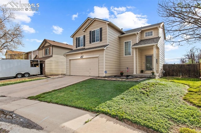 traditional-style home featuring a garage and driveway