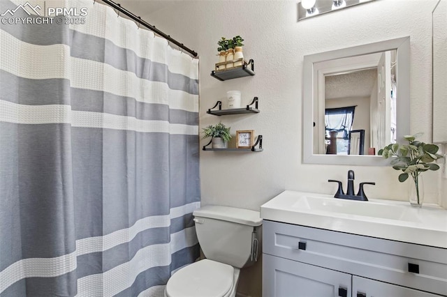bathroom featuring toilet and vanity