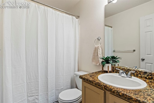 full bathroom featuring toilet and vanity