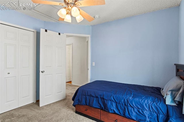 carpeted bedroom with a closet and a ceiling fan
