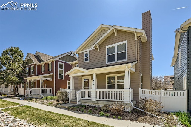 7824 Bengali Ln, Colorado Springs, CO 80923 - view of front facade featuring fence, covered porch, and a chimney