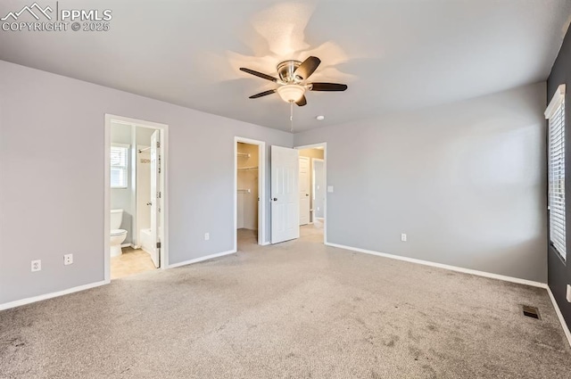7824 Bengali Ln, Colorado Springs, CO 80923 - unfurnished bedroom with visible vents, baseboards, a walk in closet, carpet flooring, and ensuite bath