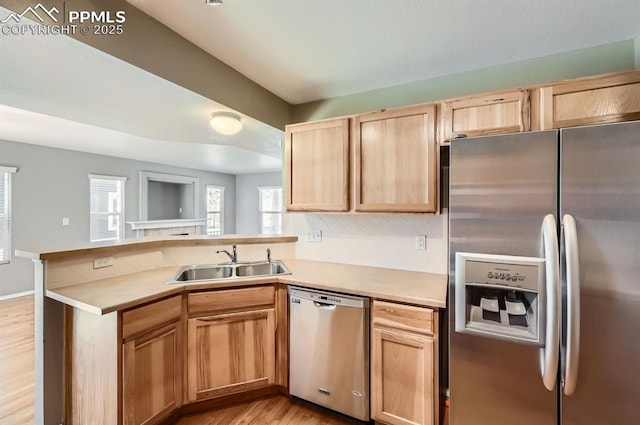 7824 Bengali Ln, Colorado Springs, CO 80923 - kitchen featuring appliances with stainless steel finishes, light brown cabinetry, a sink, light countertops, and a peninsula