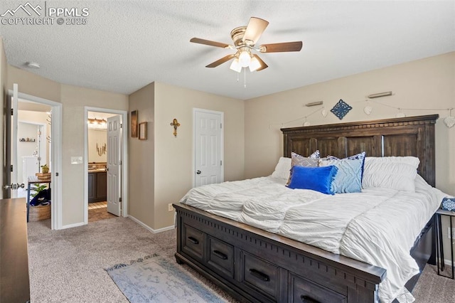 bedroom with light colored carpet, baseboards, ensuite bathroom, and a ceiling fan