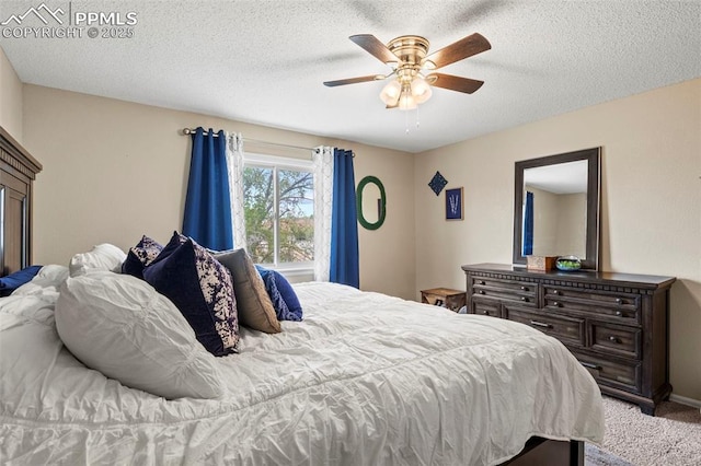 bedroom with carpet flooring, ceiling fan, and a textured ceiling