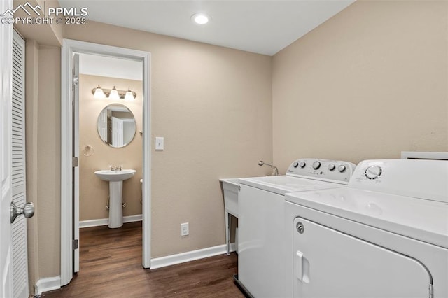 laundry area featuring washing machine and dryer, dark wood finished floors, baseboards, and recessed lighting