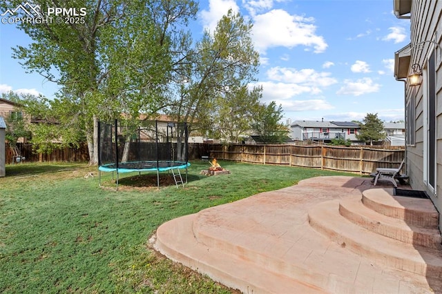 view of yard featuring a trampoline and a patio area