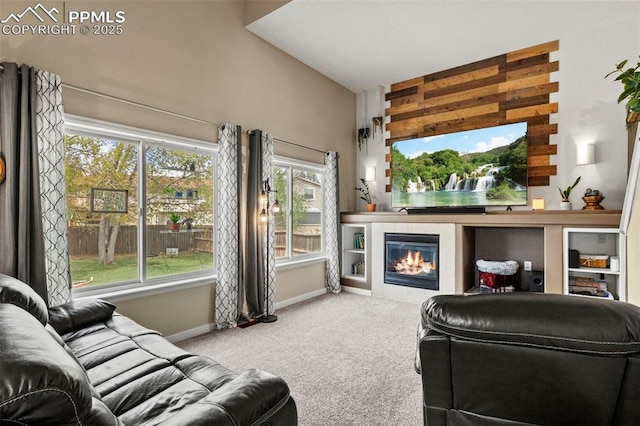 carpeted living area featuring baseboards, a tile fireplace, healthy amount of natural light, and lofted ceiling