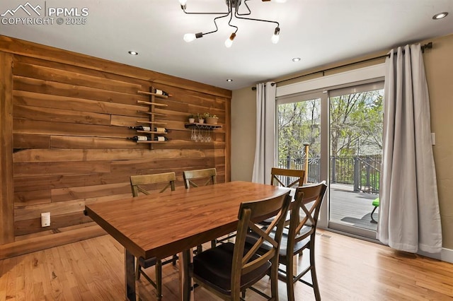 15 Newport Cir, Colorado Springs, CO 80906 - dining space featuring recessed lighting, light wood-type flooring, wooden walls, and a notable chandelier
