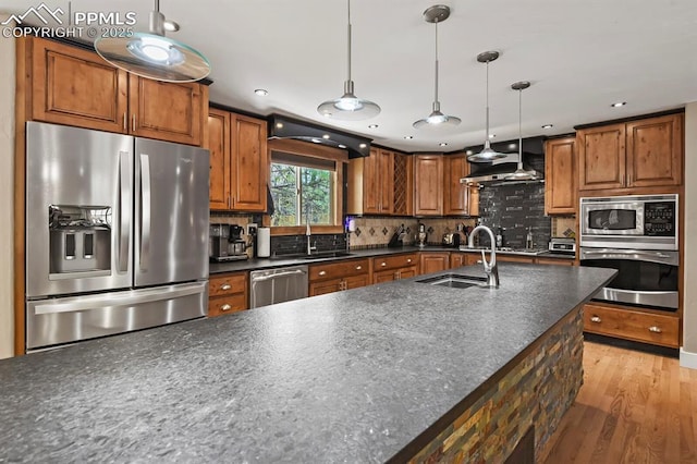 15 Newport Cir, Colorado Springs, CO 80906 - kitchen featuring extractor fan, dark countertops, appliances with stainless steel finishes, and a sink