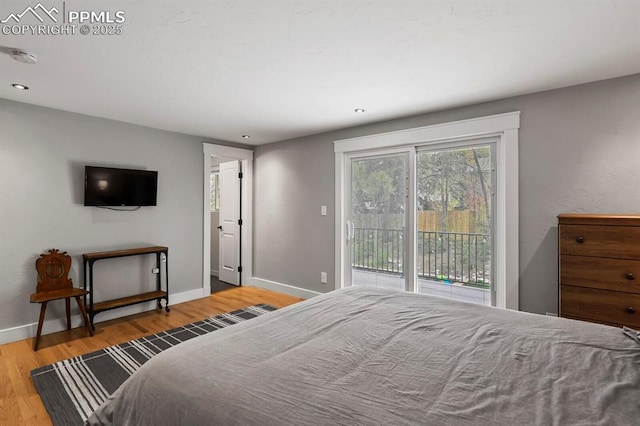 15 Newport Cir, Colorado Springs, CO 80906 - bedroom featuring access to outside, baseboards, recessed lighting, and wood finished floors