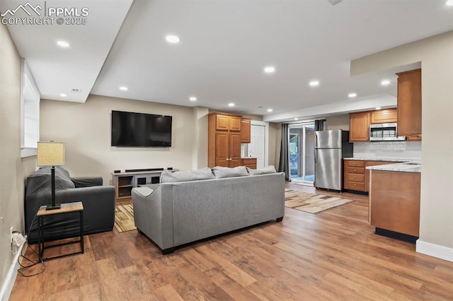 15 Newport Cir, Colorado Springs, CO 80906 - living room featuring baseboards, recessed lighting, and light wood-style flooring
