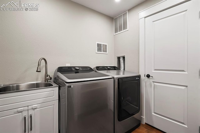 15 Newport Cir, Colorado Springs, CO 80906 - clothes washing area with cabinet space, separate washer and dryer, visible vents, and a sink