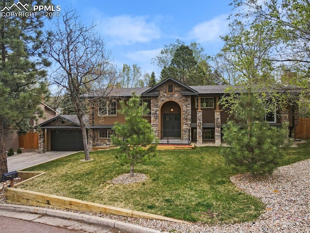 15 Newport Cir, Colorado Springs, CO 80906 - view of front of home with a garage, fence, driveway, and a front yard