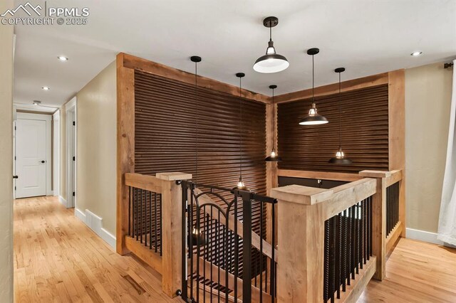 15 Newport Cir, Colorado Springs, CO 80906 - corridor featuring baseboards, recessed lighting, wood finished floors, and an upstairs landing