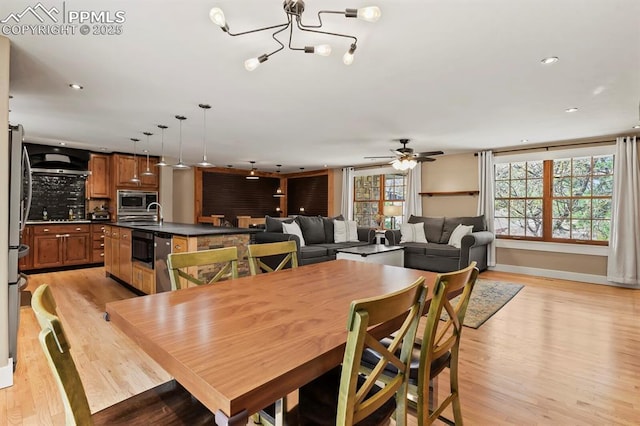 15 Newport Cir, Colorado Springs, CO 80906 - dining room with recessed lighting, light wood finished floors, ceiling fan with notable chandelier, and baseboards