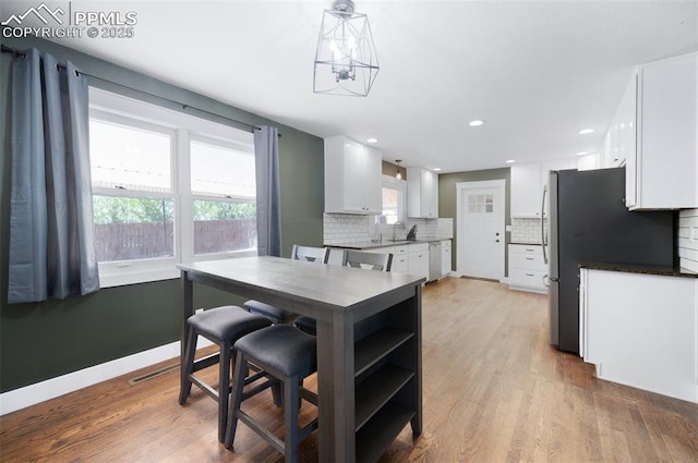 208 Davie Dr, Colorado Springs, CO 80911 - dining area featuring recessed lighting, baseboards, and light wood finished floors