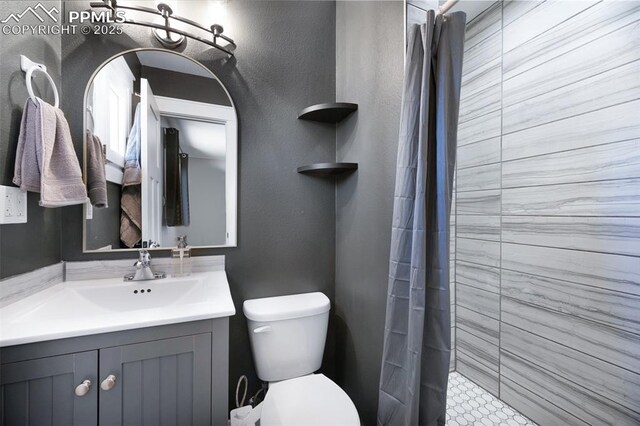 208 Davie Dr, Colorado Springs, CO 80911 - full bath featuring vanity, toilet, and tiled shower