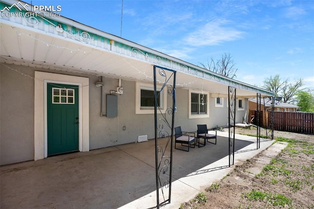 208 Davie Dr, Colorado Springs, CO 80911 - back of property featuring stucco siding, a patio area, and fence