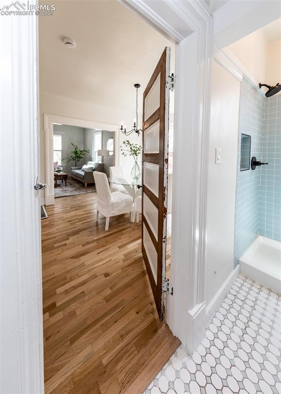 interior space featuring baseboards, an inviting chandelier, and light wood finished floors