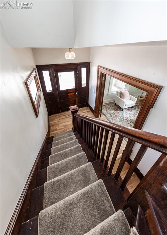 stairway featuring a towering ceiling