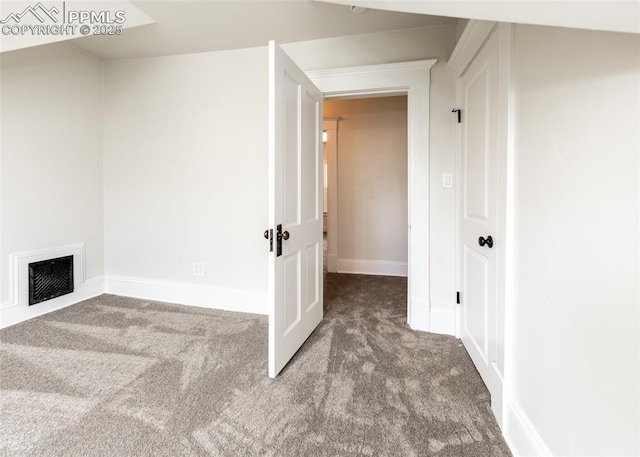 interior space featuring carpet flooring, baseboards, and visible vents