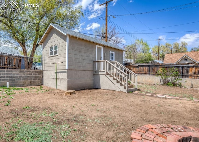 back of property with a fenced backyard