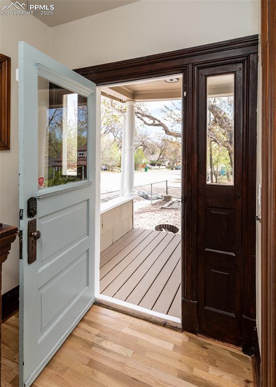 doorway to outside with light wood-type flooring