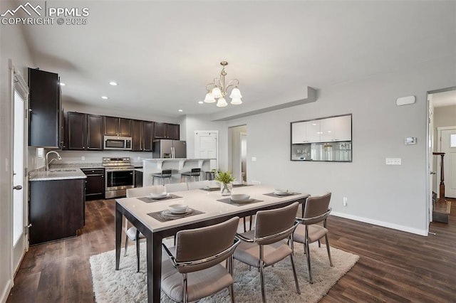 7318 Dutch Loop, Colorado Springs, CO 80925 - dining area with baseboards, recessed lighting, dark wood-style floors, and a notable chandelier