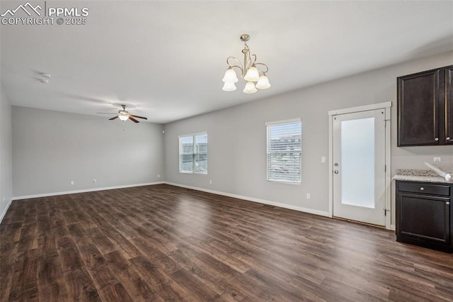 7318 Dutch Loop, Colorado Springs, CO 80925 - unfurnished living room featuring baseboards, dark wood finished floors, and ceiling fan with notable chandelier