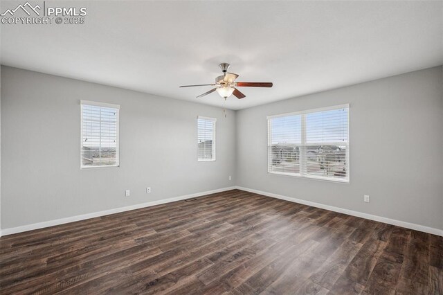 7318 Dutch Loop, Colorado Springs, CO 80925 - spare room with a ceiling fan, baseboards, and dark wood finished floors