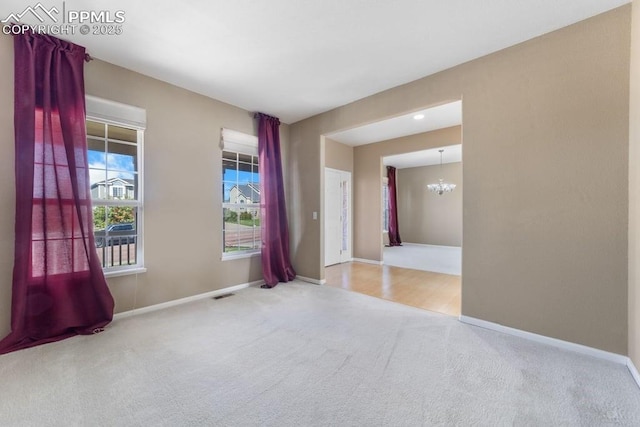 9089 Royal Melbourne Cir, Peyton, CO 80831 - carpeted empty room with baseboards, visible vents, and a chandelier