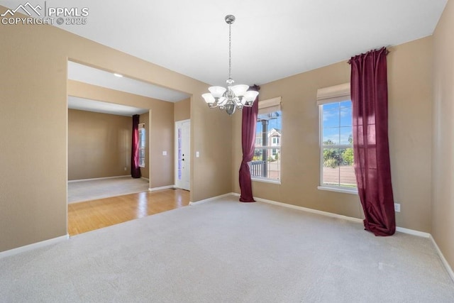 9089 Royal Melbourne Cir, Peyton, CO 80831 - carpeted spare room featuring baseboards and a notable chandelier