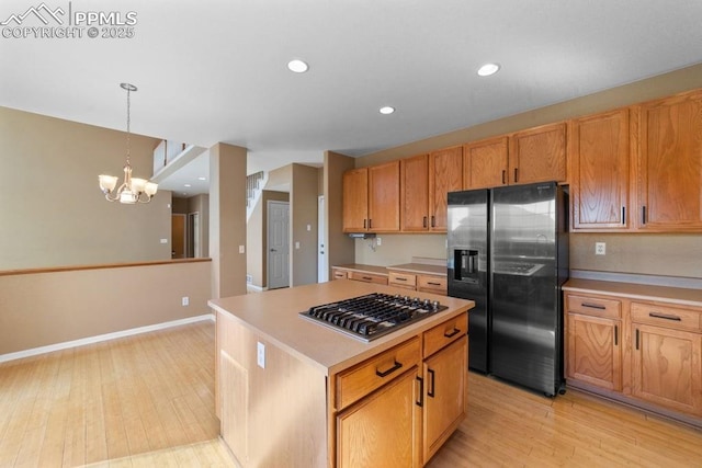9089 Royal Melbourne Cir, Peyton, CO 80831 - kitchen featuring light countertops, stainless steel appliances, a chandelier, and light wood finished floors