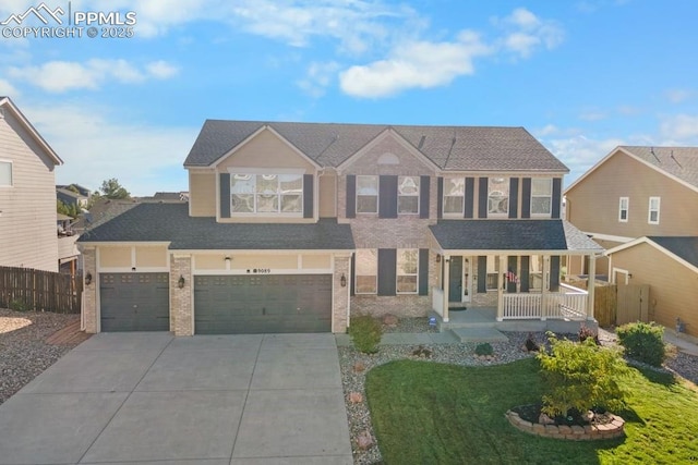9089 Royal Melbourne Cir, Peyton, CO 80831 - traditional home featuring covered porch, brick siding, fence, a front lawn, and concrete driveway